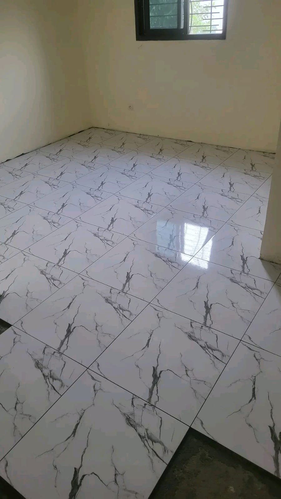 Light marble-look floor in an unfinished room
