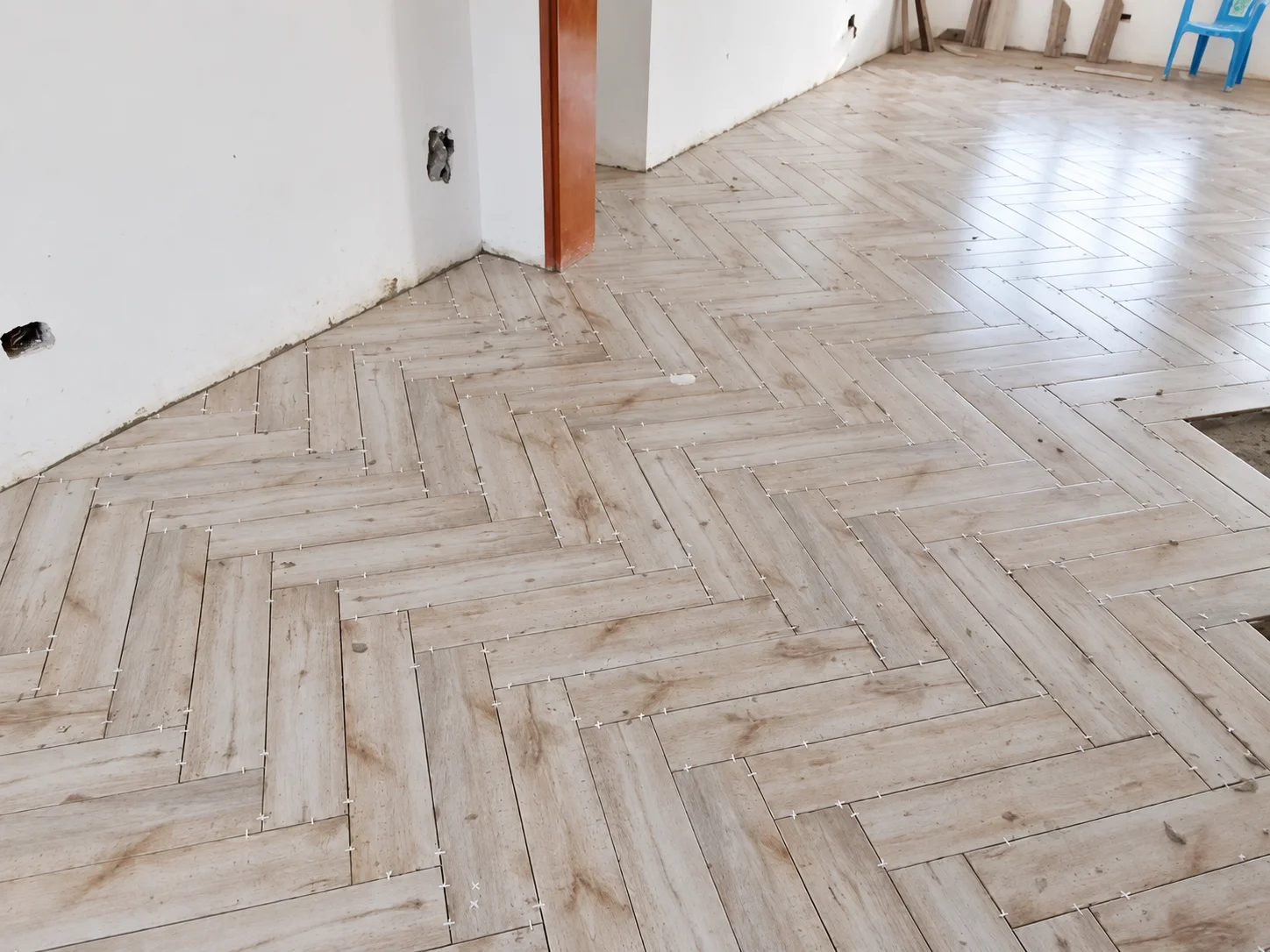 Light herringbone floor in a room under construction